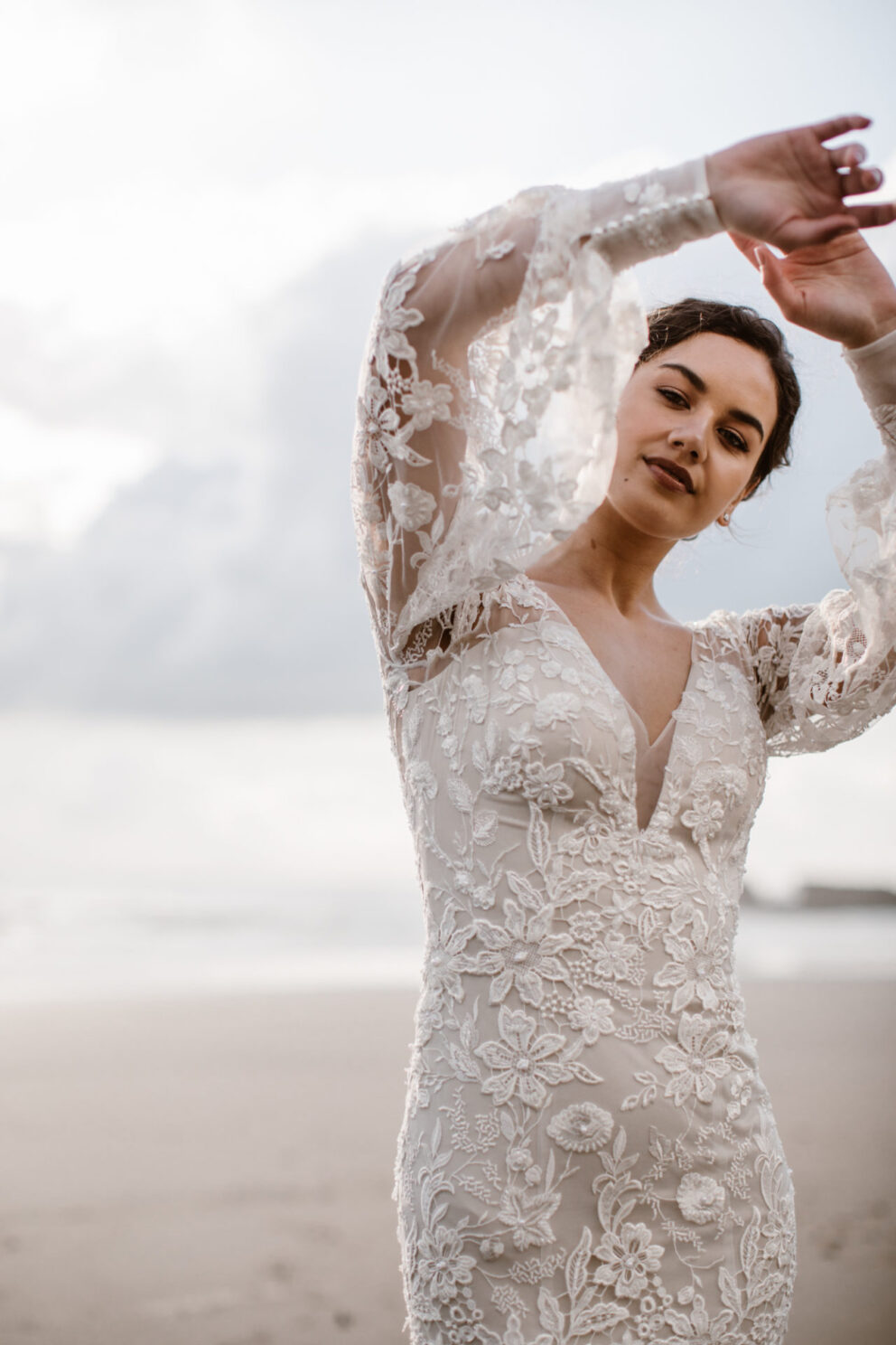 Natalia is heavily beaded with a low V neck, a delicate shear back and bell sleeves. made with stetch fabric for comfort and an ease on your big day.