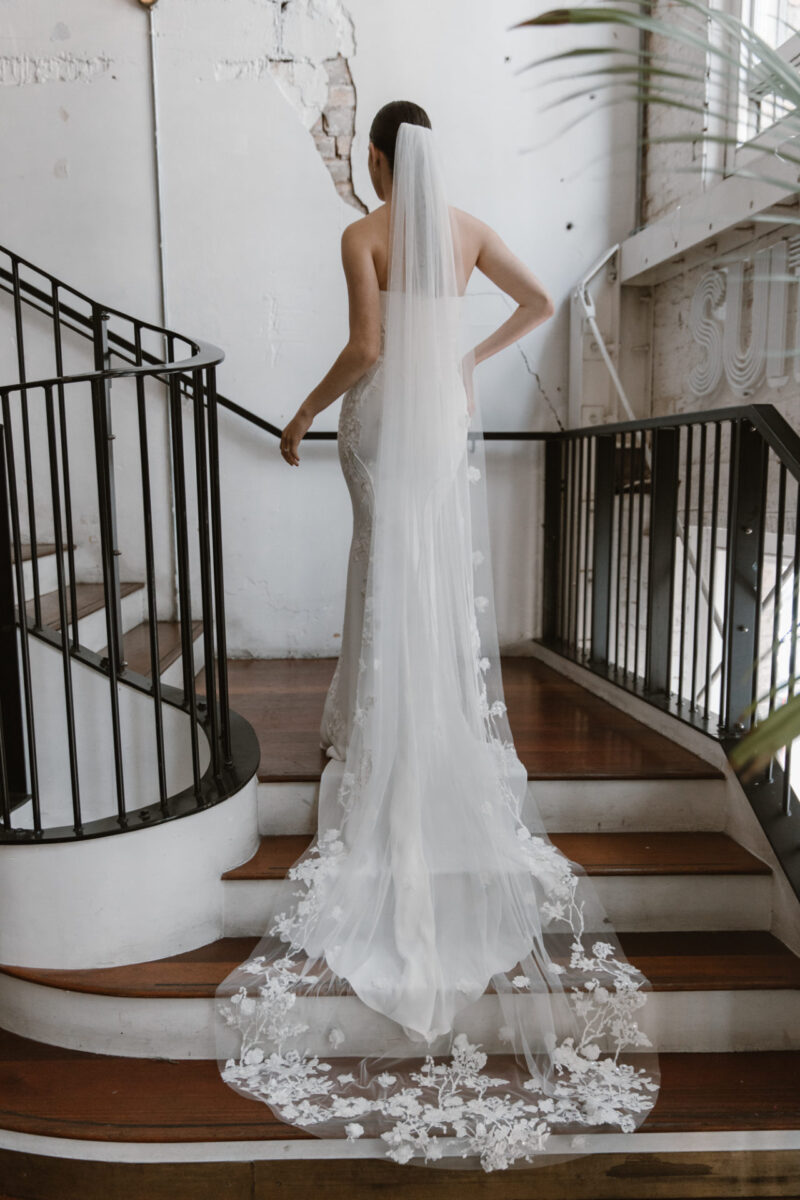 Adorned with delicate 3D flowers this cathedral length raw edge tulle veil is everything you could ask for. Adding drama and luxury to your gown