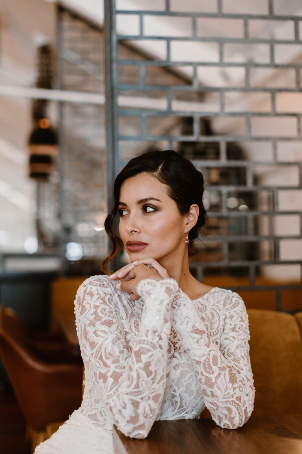 This stunning high neck long sleeve wedding gown is pure elegance. A delicate floral lace carefully hugs the body accentuating the fit & flare silhouette. stunning high neck long sleeve wedding gown is pure elegance. A delicate floral lace carefully hugs the body accentuating the fit & flare silhouette.