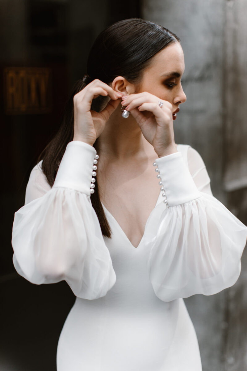 These graceful chiffon balloon sleeves add a little something extra to any dress. Ivory cuffs with pearl button detailing finish the sheer sleeves.