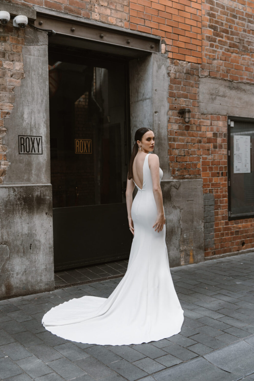 A clean, classic Mermaid dress in crepe, perfect for the minimalist bride. The V-neck & open back with carefully placed seam lines enhances the silhouette