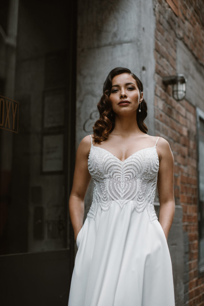 Our Suri gown is a classic A-line gown with a beaded illusion bodice, hidden pockets & soft satin skirt designed to be worn by women of any shape & size