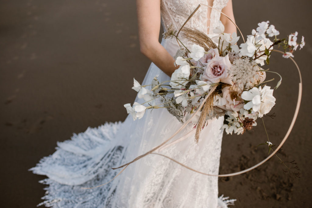 Cherish wedding gown with bouquet by Lydia Reusser