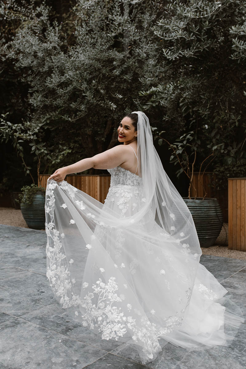 Celeste is a fun & youthful princess wedding gown, scattered in delicate 3D flower lace & a sparkle tulle skirt bringing a beautiful shimmer to this dress.