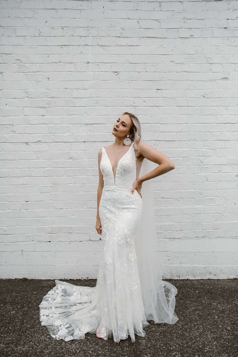 The floral fabric of our Sasha Fishtail wedding dress is perfect for an outdoor wedding, a plunging neckline flatters your bust & accentuates mermaid shape.