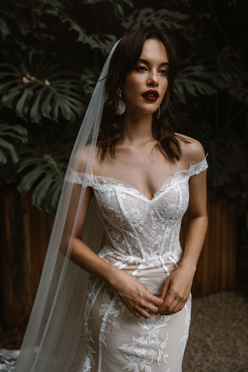 Timeless romance & modern design go hand-in-hand with this exquisite off the shoulder fit & flare wedding gown, perfect for enhancing the feminine curve.