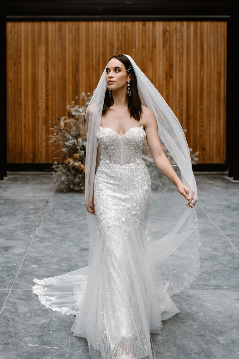 This wedding dress is made to stand the test of time, a strapless sweetheart mermaid silhouette with linear sequin detailing, floral lace & soft tulle skirt