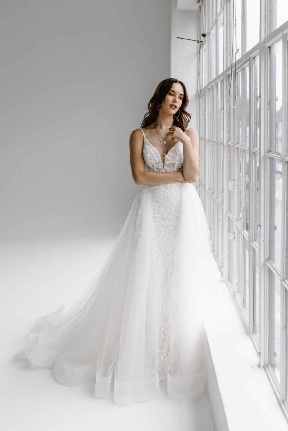 This wedding dress is the essence of love, from the soft illuison bodice to the fishtail shape and detachable half skirt which blooms behind